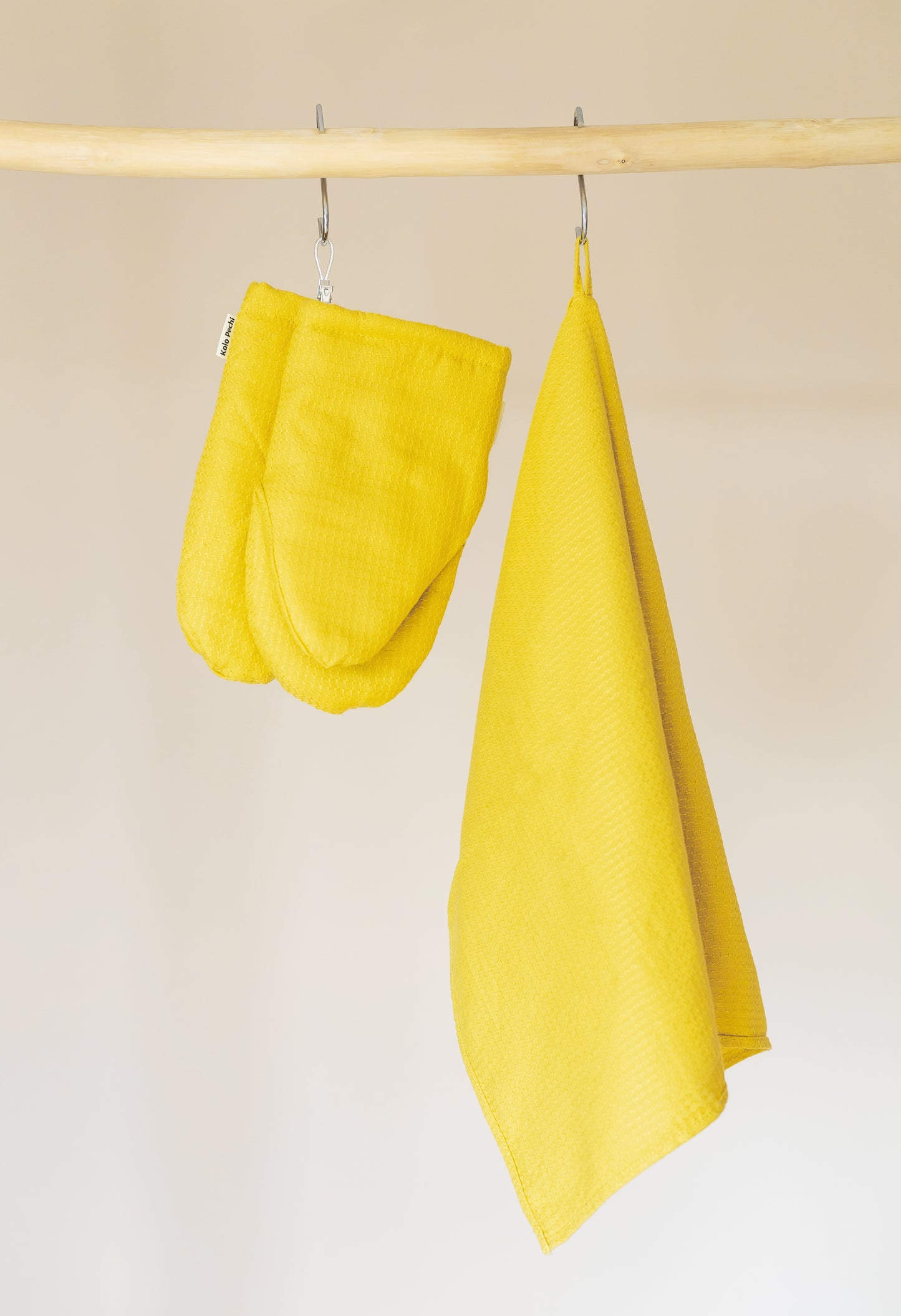 Oven mitts and a kitchen towel in yellow hemp fabric from Odesa Sea collection by Kolo Pechi