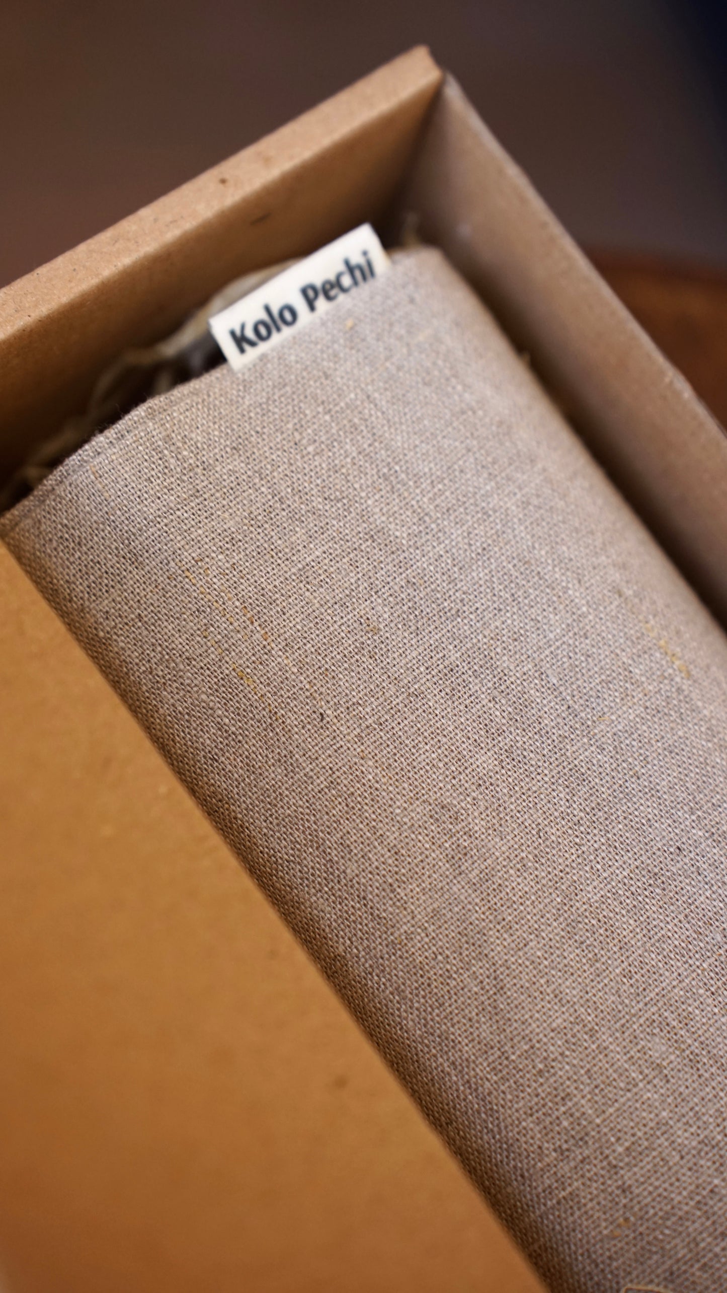Textured linen bread bag inside a cardboard box with 'Kolo Pechi' label.