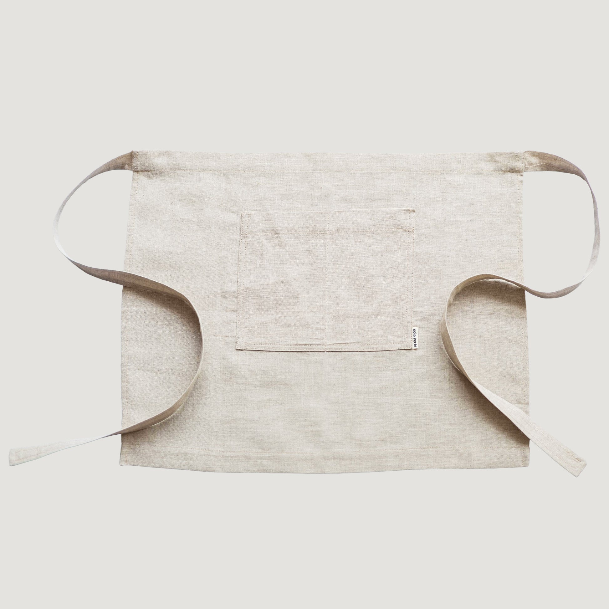 Close-up of natural linen fabric texture — Polissia waist apron by Kolo Pechi