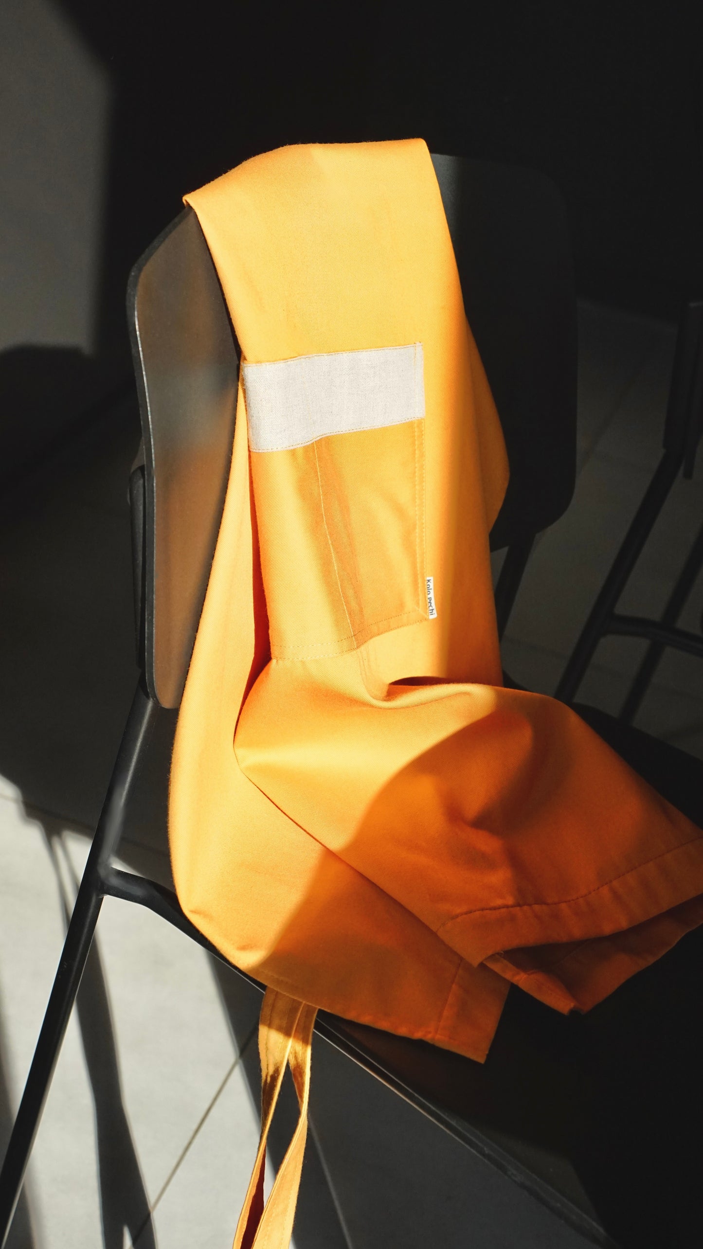 Sunset Bib Apron — warm cotton, adjustable neck loop and front pocket, handcrafted in Ukraine