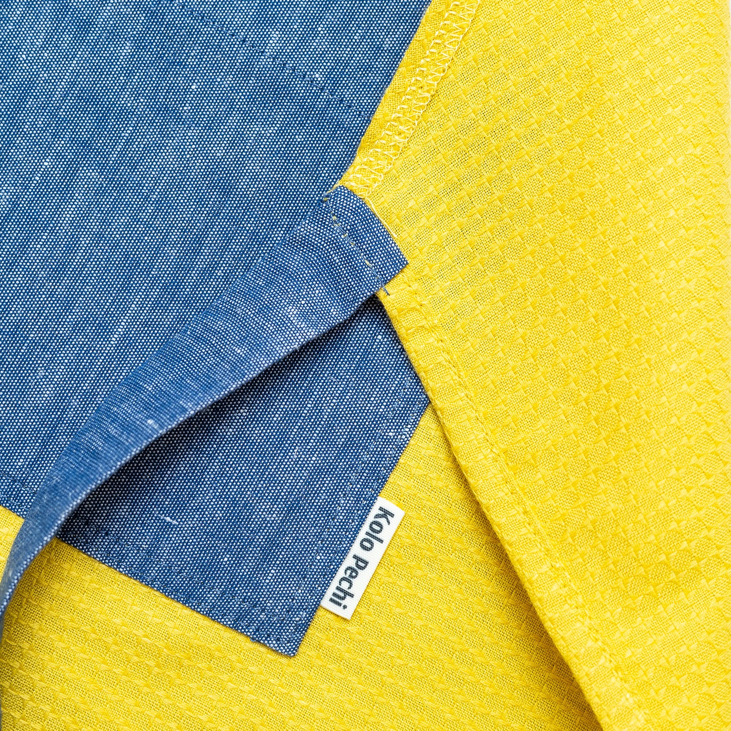 Hemp Apron "Odesa Sea" | Sand — apron detail with Kolo Pechi logo. Handmade in Ukraine.