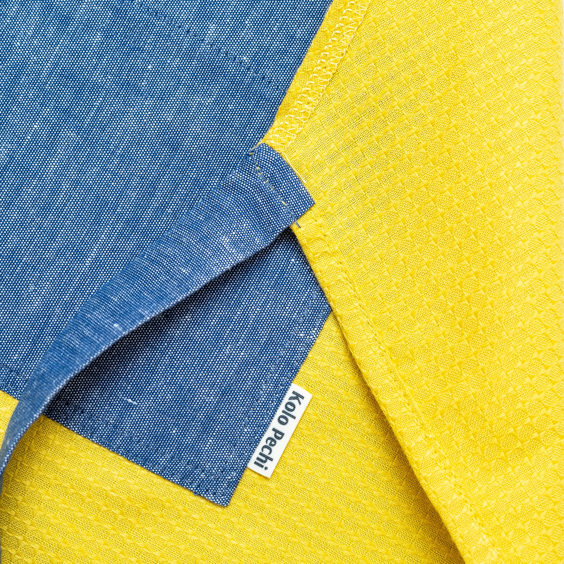 Hemp Apron "Odesa Sea" | Sand — apron detail with Kolo Pechi logo. Handmade in Ukraine.