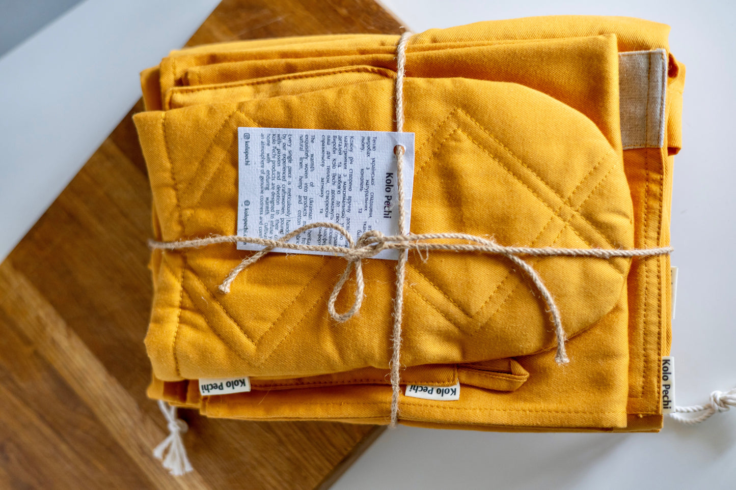  Kitchen Textile Set "Sunset" — full set laid flat, warm sunset cotton, natural materials, Kolo Pechi