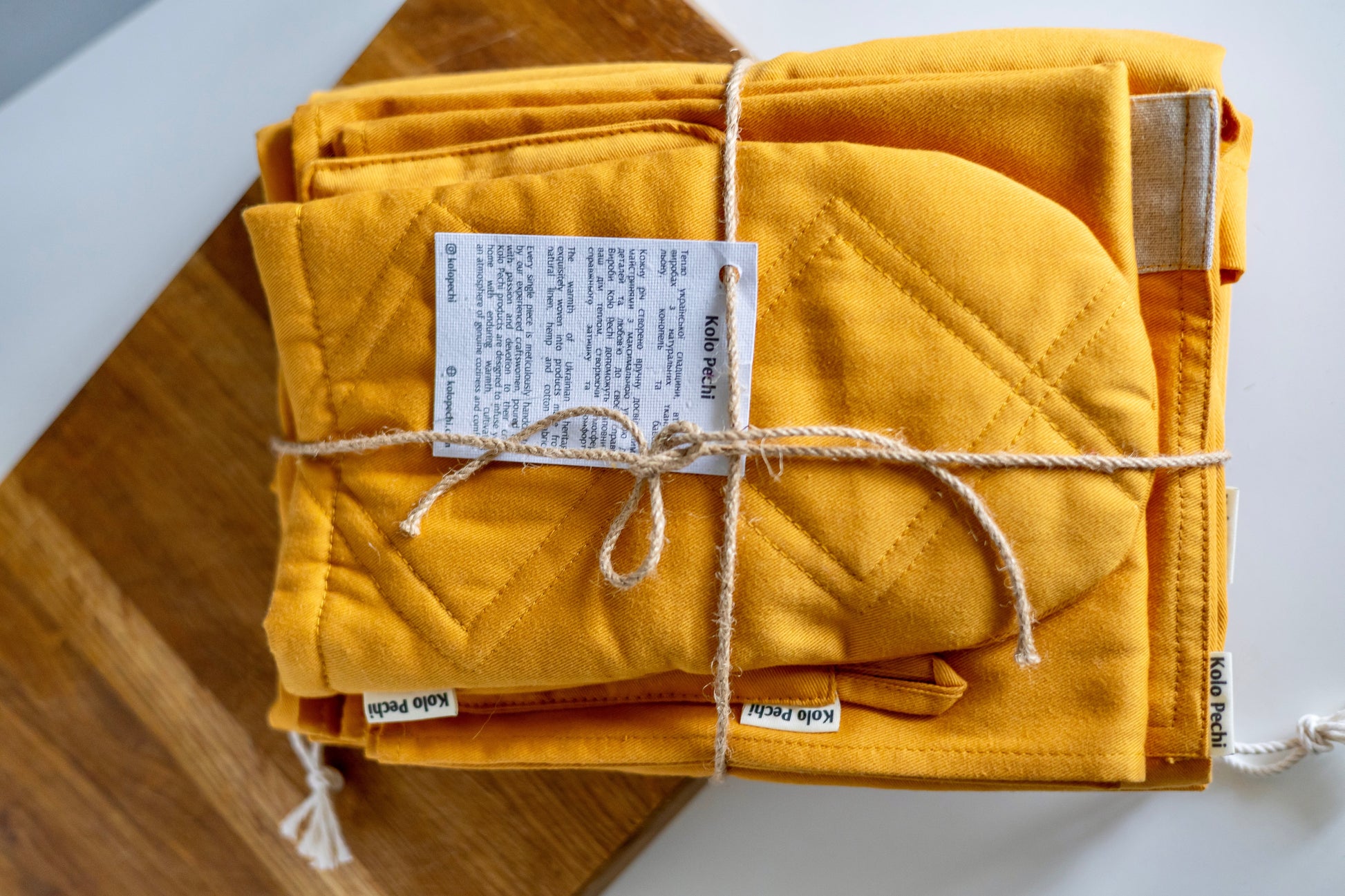  Kitchen Textile Set "Sunset" — full set laid flat, warm sunset cotton, natural materials, Kolo Pechi