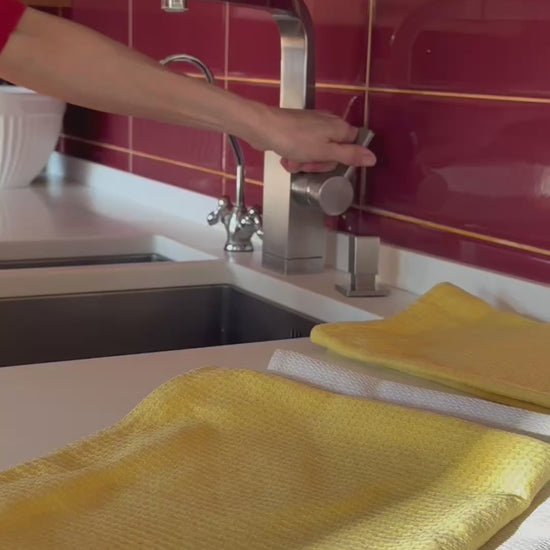 Hemp kitchen towels from Odesa Sea and Steppe being used to wipe clay cup